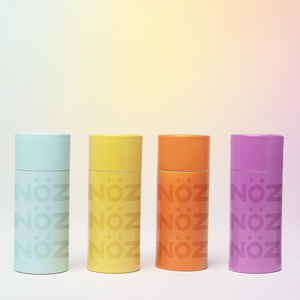 Blue, Yellow, orange and purple Nöz sunscreen bottles set horizontally next to one another 