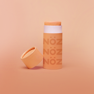 Zoomed in view of opened Nöz peachy orange tanning Sunscreen