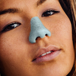 Up close view of girl wearing Nöz light Blue Sunscreen on nose